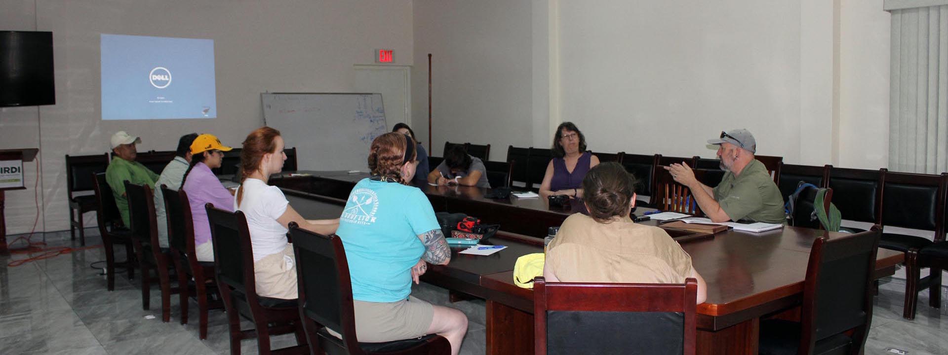 Douglas Hume, Students, and Community Members at a Sugar Industry Research and Development Institute Meeting, Belize, 2018